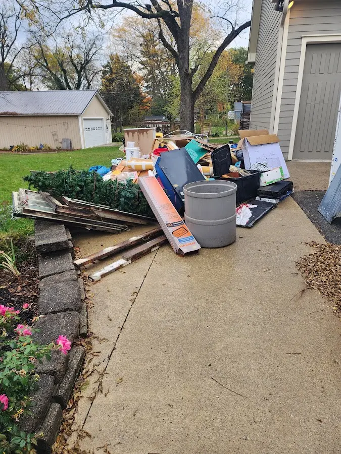 Dumpster being loaded with debris for Commercial Dumpster Rental in Lake Hallie